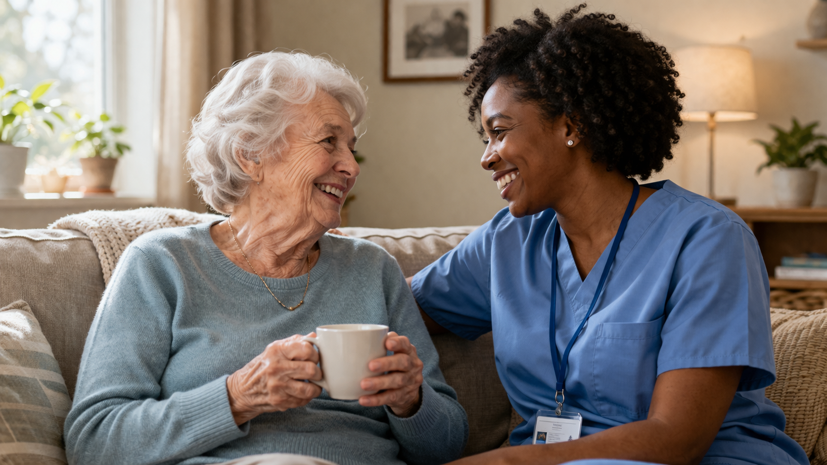 two women sitting on the couch enjoying each other's company through in-home companion care
