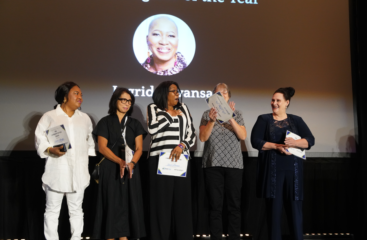 Ingrid Mwansa holds her HCAOA 2026 Caregiver of the Year certificate, standing with B'zoe Care founder Prossie Lockett at the awards ceremony in Orlando